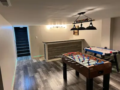 a living room with a foosball table and a fireplace at Hillside country cabin in Lancaster