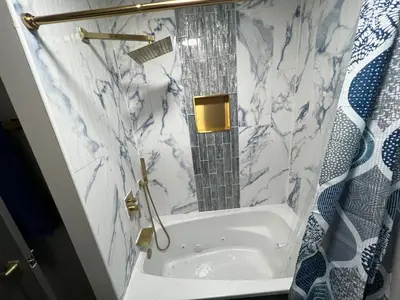 a bathroom with a tub with a mirror in it at Hillside country cabin in Lancaster