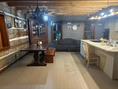 a kitchen with a table and a couch in a room at Farmhouse Cabin in Ashland
