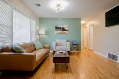 a living room with a couch and a chair at El Retro- Mid Century Ranch near Horse Park & Rupp in Lexington