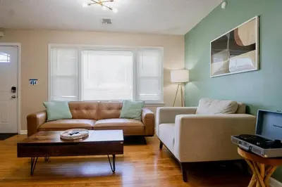 a living room with a couch and a table at El Retro- Mid Century Ranch near Horse Park & Rupp in Lexington
