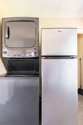 a refrigerator with a microwave on top of it at El Retro- Mid Century Ranch near Horse Park & Rupp in Lexington