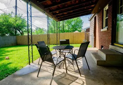 a patio with a table and four chairs at El Retro- Mid Century Ranch near Horse Park & Rupp in Lexington