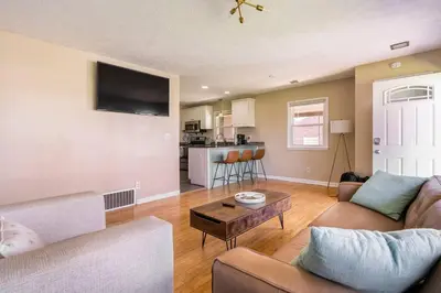 a living room with a couch and a table at El Retro- Mid Century Ranch near Horse Park & Rupp in Lexington
