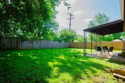 a backyard with a table and chairs and a fence at El Retro- Mid Century Ranch near Horse Park & Rupp in Lexington