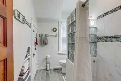 a bathroom with a toilet and a shower at 3 Mi to Cedar Point Sunny Sandusky Home with Yard in Sandusky