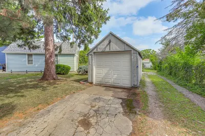 a garage in the driveway of a house at 3 Mi to Cedar Point Sunny Sandusky Home with Yard in Sandusky