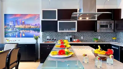 a kitchen with a table with fruit on it at Downtown Cleveland- Steps to Sports & Events condo in Cleveland