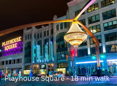 a large building with a lit up sign in front of it at Downtown Cleveland- Steps to Sports & Events condo in Cleveland