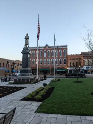 a large building with a statue in the middle of a park at Clay St Suite in Millersburg