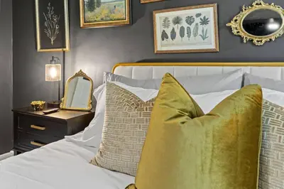 a bedroom with a bed with a mirror and a table at The Luxe Hot Tub Private Bar 12 Min to Horse Park in Georgetown