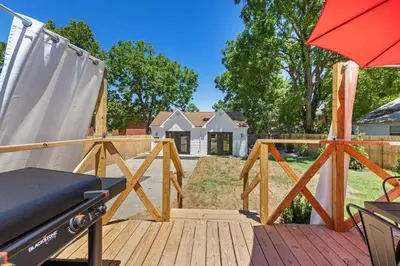 a deck with a bench and an umbrella at The Luxe Hot Tub Private Bar 12 Min to Horse Park in Georgetown