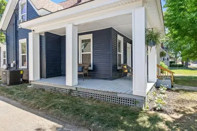 a porch with a table and chairs on a house at The Luxe Hot Tub Private Bar 12 Min to Horse Park in Georgetown