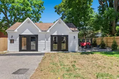a white house with a fence and a yard at The Luxe Hot Tub Private Bar 12 Min to Horse Park in Georgetown