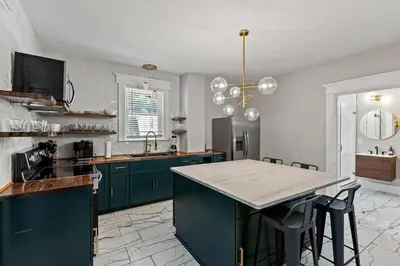 a kitchen with green cabinets and a counter top at The Luxe Hot Tub Private Bar 12 Min to Horse Park in Georgetown