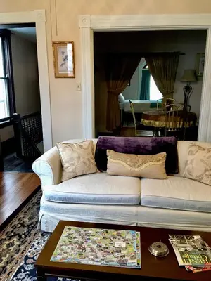a living room with a couch and a table at Historic Upstairs Apartment in Bellevue