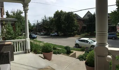 a porch with a car parked in a parking lot at Historic Upstairs Apartment in Bellevue