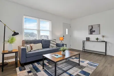 a living room with a couch and a table at The Northtowne Getaway in Columbus