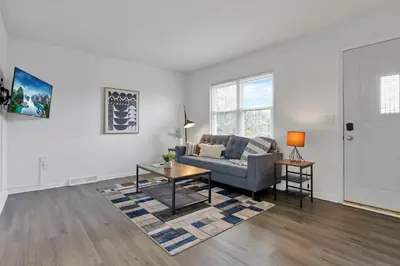a living room with a couch and a table at The Northtowne Getaway in Columbus