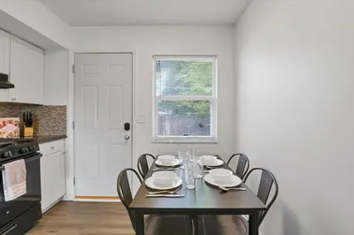 a dining room with a black table and chairs at The Northtowne Getaway in Columbus