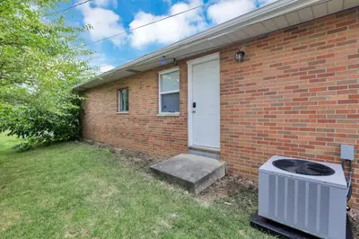 a brick house with a heater in the yard at The Northtowne Getaway in Columbus