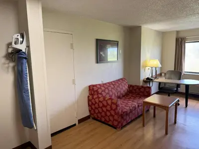 a living room with a couch and a table at Sycamore Suites in Elyria