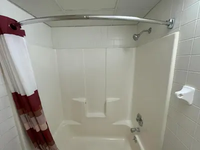 a bathroom with a shower with a shower curtain at Sycamore Suites in Elyria
