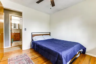 a bedroom with a bed with a blue comforter at 4 Mi to MetroParks Ice Rink Pet-Friendly Getaway in Dayton