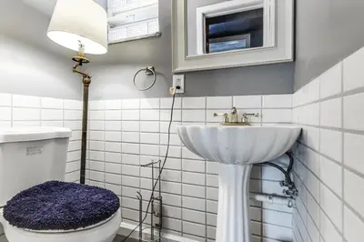 a white bathroom with a sink and a toilet at 4 Mi to MetroParks Ice Rink Pet-Friendly Getaway in Dayton