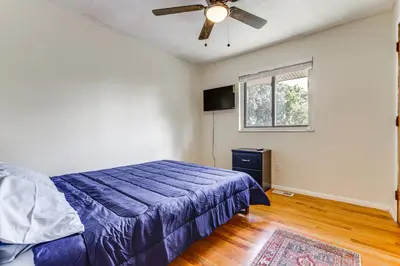 a bedroom with a bed and a ceiling fan at 4 Mi to MetroParks Ice Rink Pet-Friendly Getaway in Dayton