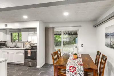 a kitchen with a dining room table with chairs and a tableablish at 4 Mi to MetroParks Ice Rink Pet-Friendly Getaway in Dayton