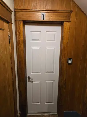 a white door in a room with a wooden wall at Unit 1 at Oilgate at Oakdale in Akron