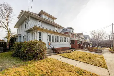 a large house on a street with at Unit 1 at Oilgate at Oakdale in Akron