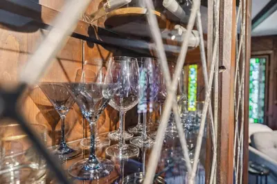 a bunch of wine glasses sitting on a shelf at Enchanted Castle - Your Royal Getaway Awaits in Cleveland