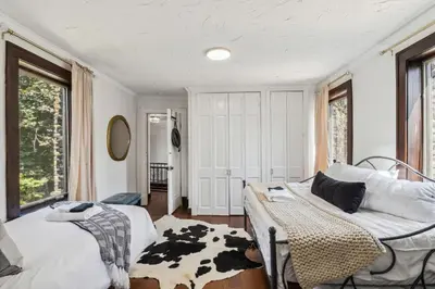 a living room with a cow blanket on a bed at Enchanted Castle - Your Royal Getaway Awaits in Cleveland