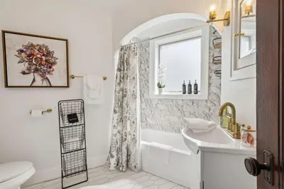 a bathroom with a tub and a toilet and a sink at Enchanted Castle - Your Royal Getaway Awaits in Cleveland