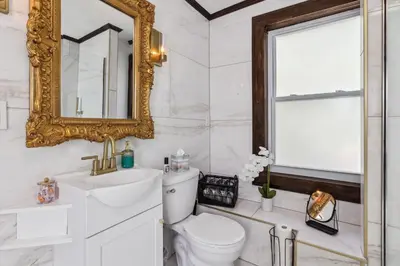 a bathroom with a toilet and a mirror at Enchanted Castle - Your Royal Getaway Awaits in Cleveland