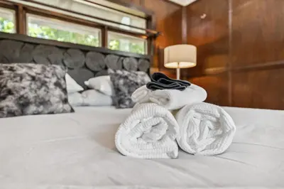 a pair of towels sitting on top of a bed at Enchanted Castle - Your Royal Getaway Awaits in Cleveland