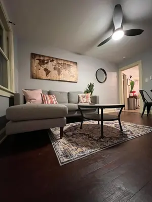 a living room with a couch and a table at Parma duplex cozy retreat in Parma