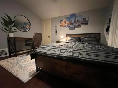 a bedroom with a bed and a desk and a chair at Parma duplex cozy retreat in Parma