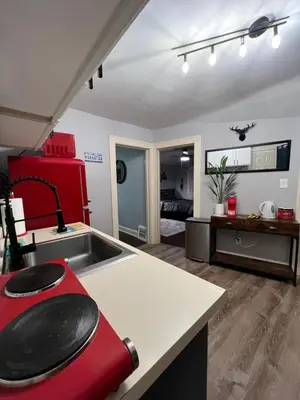 a kitchen with a sink and a red appliance at Parma duplex cozy retreat in Parma