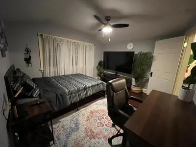 a bedroom with a bed and a desk and a table at Parma duplex cozy retreat in Parma