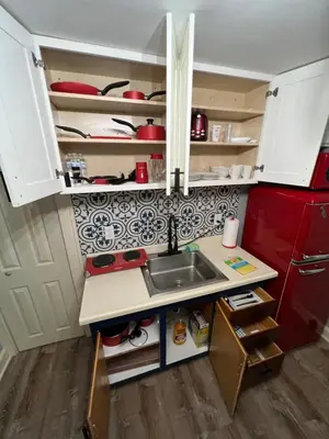 a kitchen with a sink and a red refrigerator at Parma duplex cozy retreat in Parma