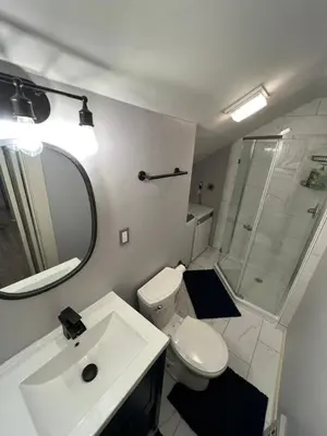 a bathroom with a toilet and a sink and a mirror at Parma duplex cozy retreat in Parma