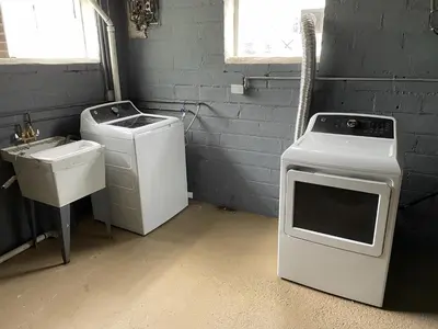 a laundry room with a washing machine and a sink at Duplex home away from home in Parma