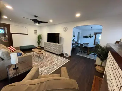 a living room with a couch and a table at Duplex home away from home in Parma