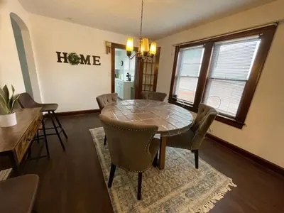 a dining room with a table and chairs at Duplex home away from home in Parma