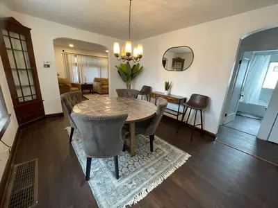 a dining room with a table and chairs at Duplex home away from home in Parma