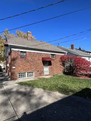 a red brick house with a driveway at Duplex home away from home in Parma