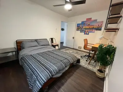 a bedroom with a bed and a desk in it at Duplex home away from home in Parma